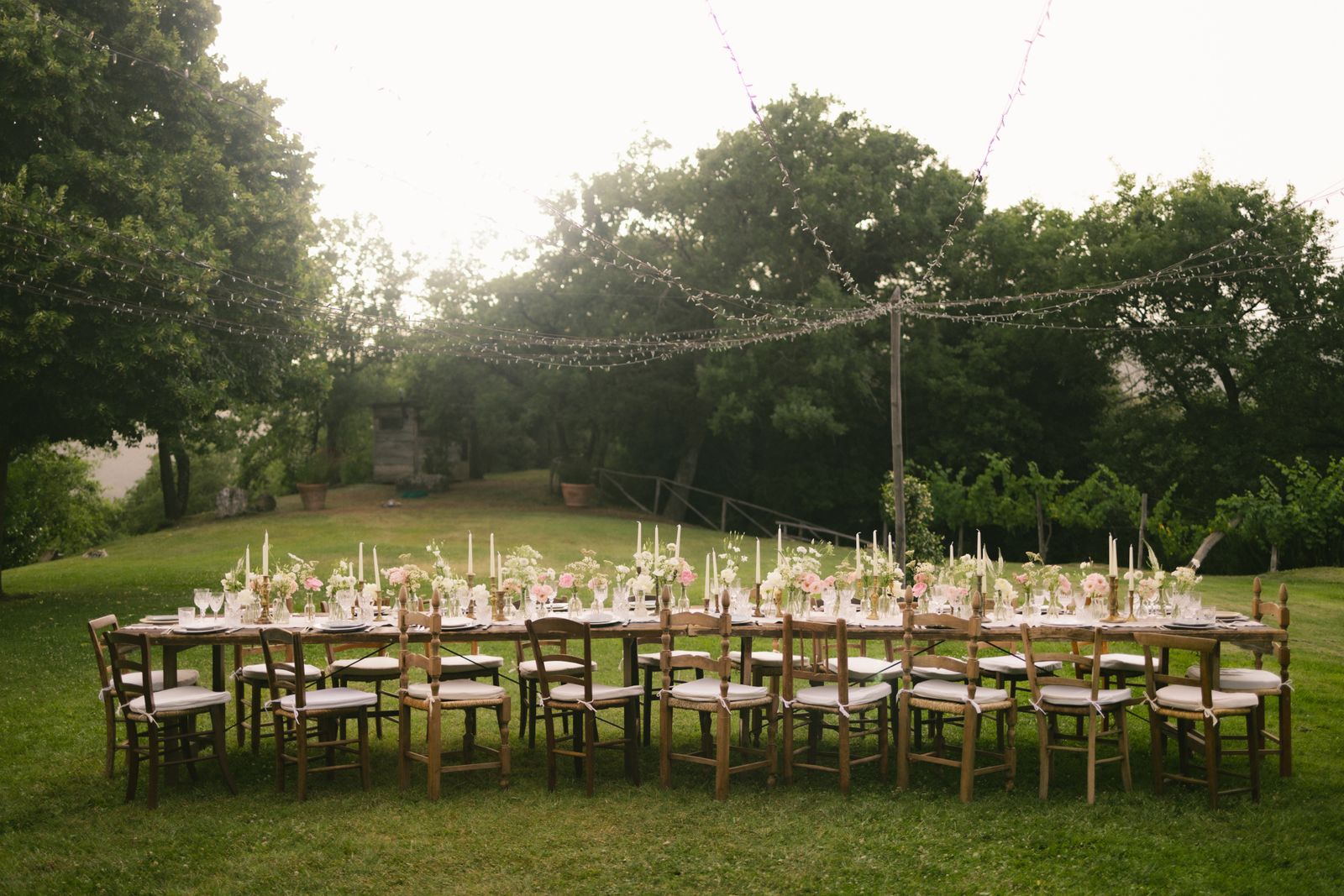 An intimate garden wedding reception with elegant flowers and a beautifully set table